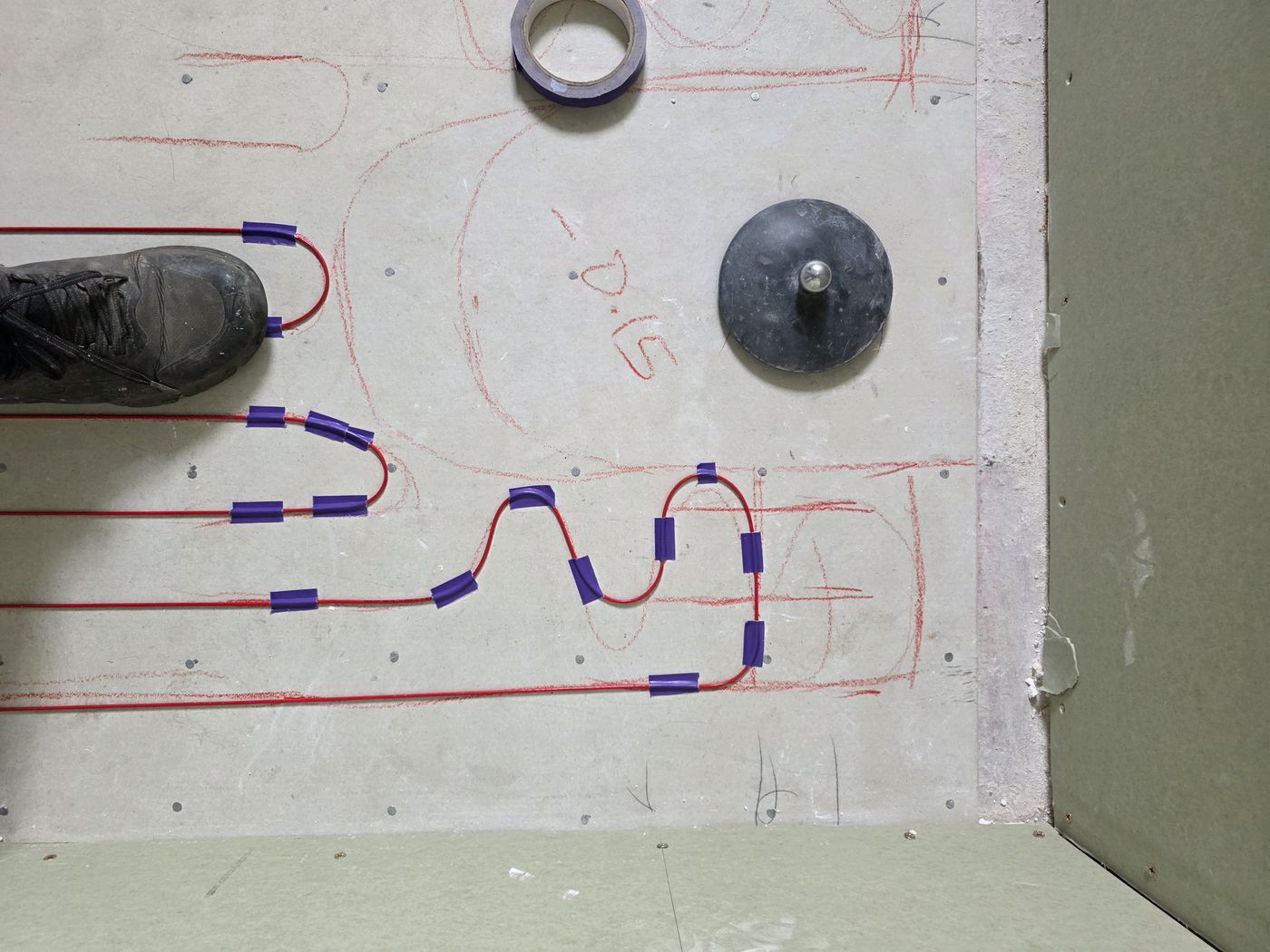 Electric underfloor heating by Floorheat NZ — the heating cable laid out across a bathroom floor before the screed goes on, the same system we fit across Central Auckland