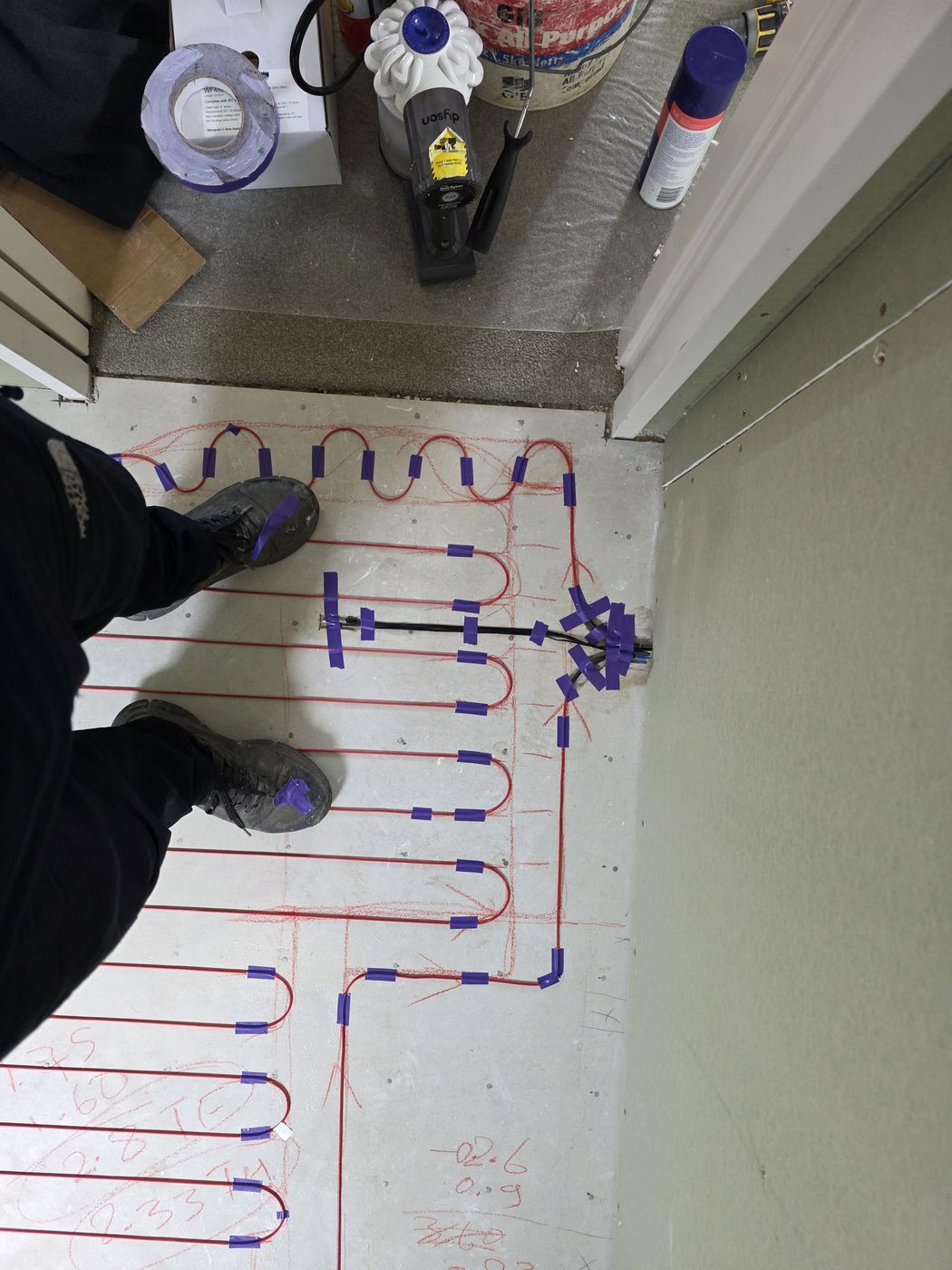 Electric underfloor heating by Floorheat NZ — the heating cable laid out across a bathroom floor before the screed goes on, the same system we fit across Central Auckland