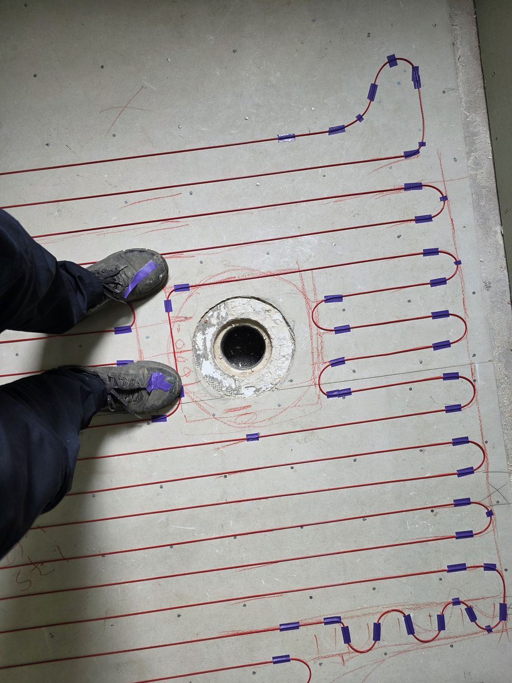 Electric underfloor heating by Floorheat NZ — the heating cable laid out across a bathroom floor before the screed goes on, the same system we fit across Central Auckland