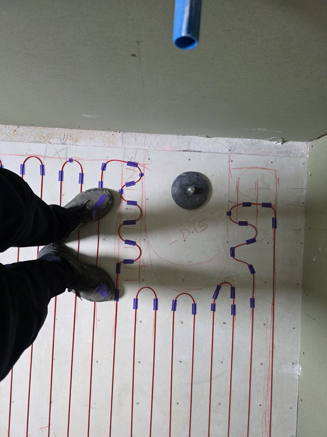 Electric underfloor heating by Floorheat NZ — the heating cable laid out across a bathroom floor before the screed goes on, the same system we fit across Central Auckland
