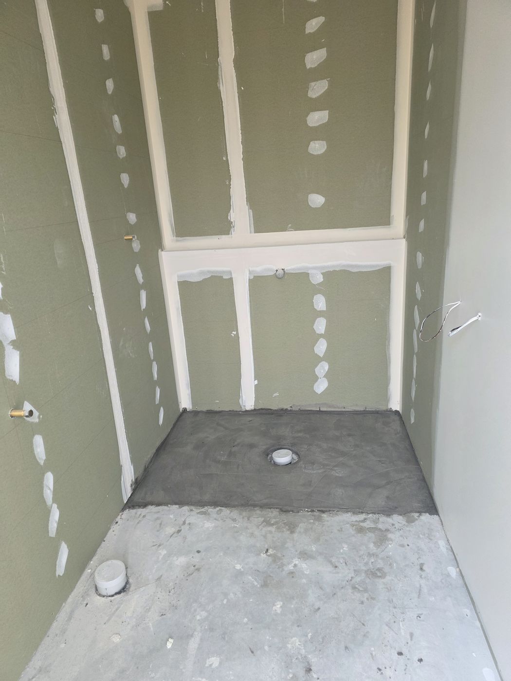 Electric underfloor heating by Floorheat NZ — the levelling screed going over the heating cable, ready for tiling, the same system we fit across West Auckland