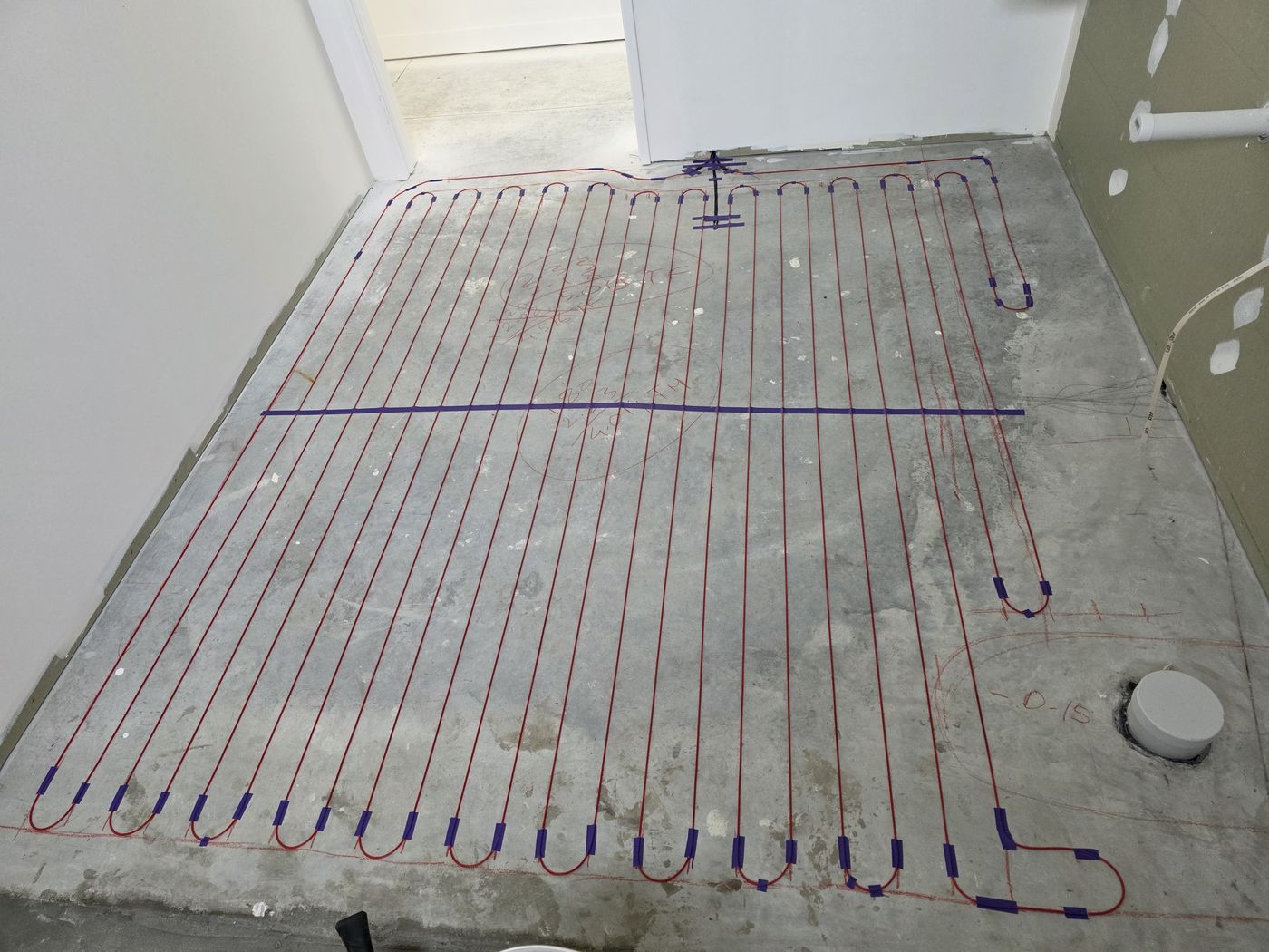 Electric underfloor heating by Floorheat NZ — the heating cable laid out across a bathroom floor before the screed goes on, the same system we fit across West Auckland