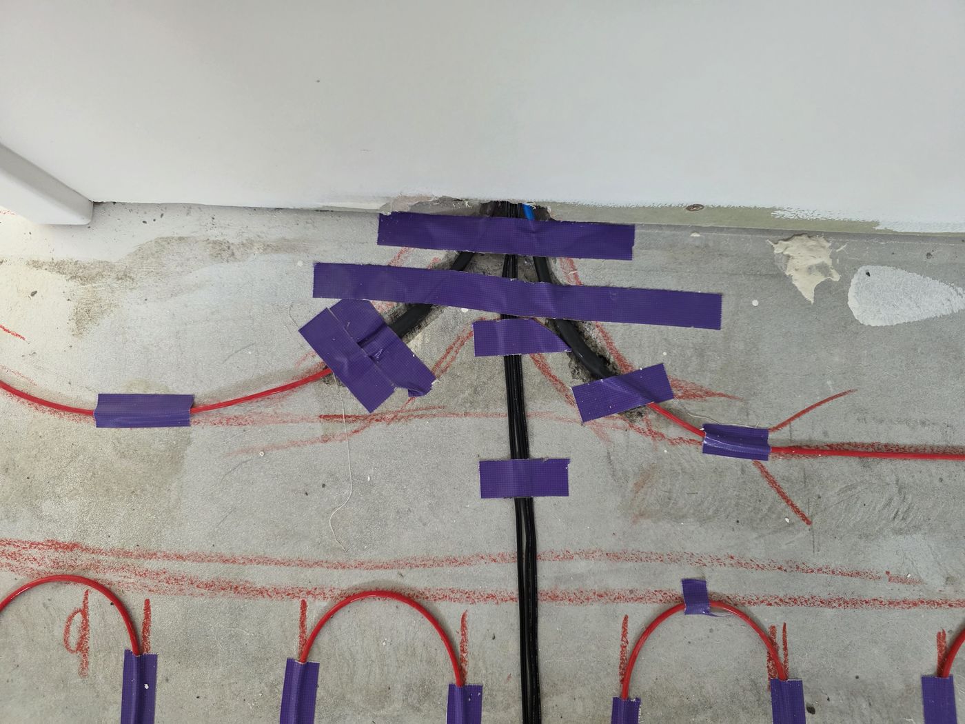 Electric underfloor heating by Floorheat NZ — the heating cable laid out across a bathroom floor before the screed goes on, the same system we fit across West Auckland