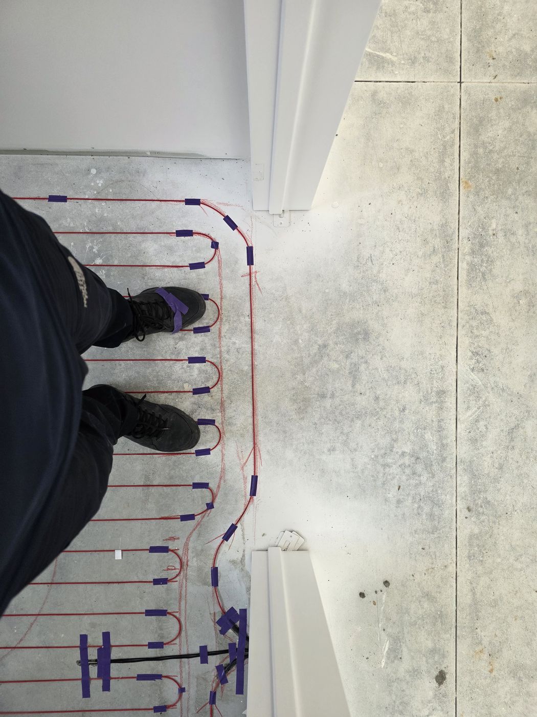 Electric underfloor heating by Floorheat NZ — the heating cable laid out across a bathroom floor before the screed goes on, the same system we fit across West Auckland