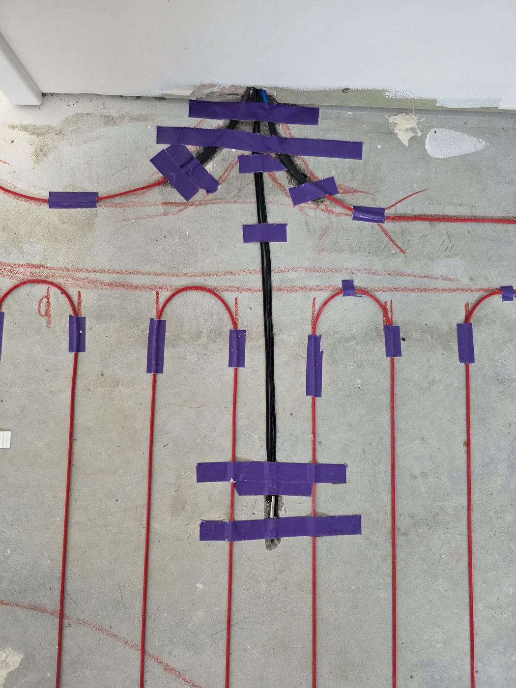 Electric underfloor heating by Floorheat NZ — the heating cable laid out across a bathroom floor before the screed goes on, the same system we fit across East Auckland