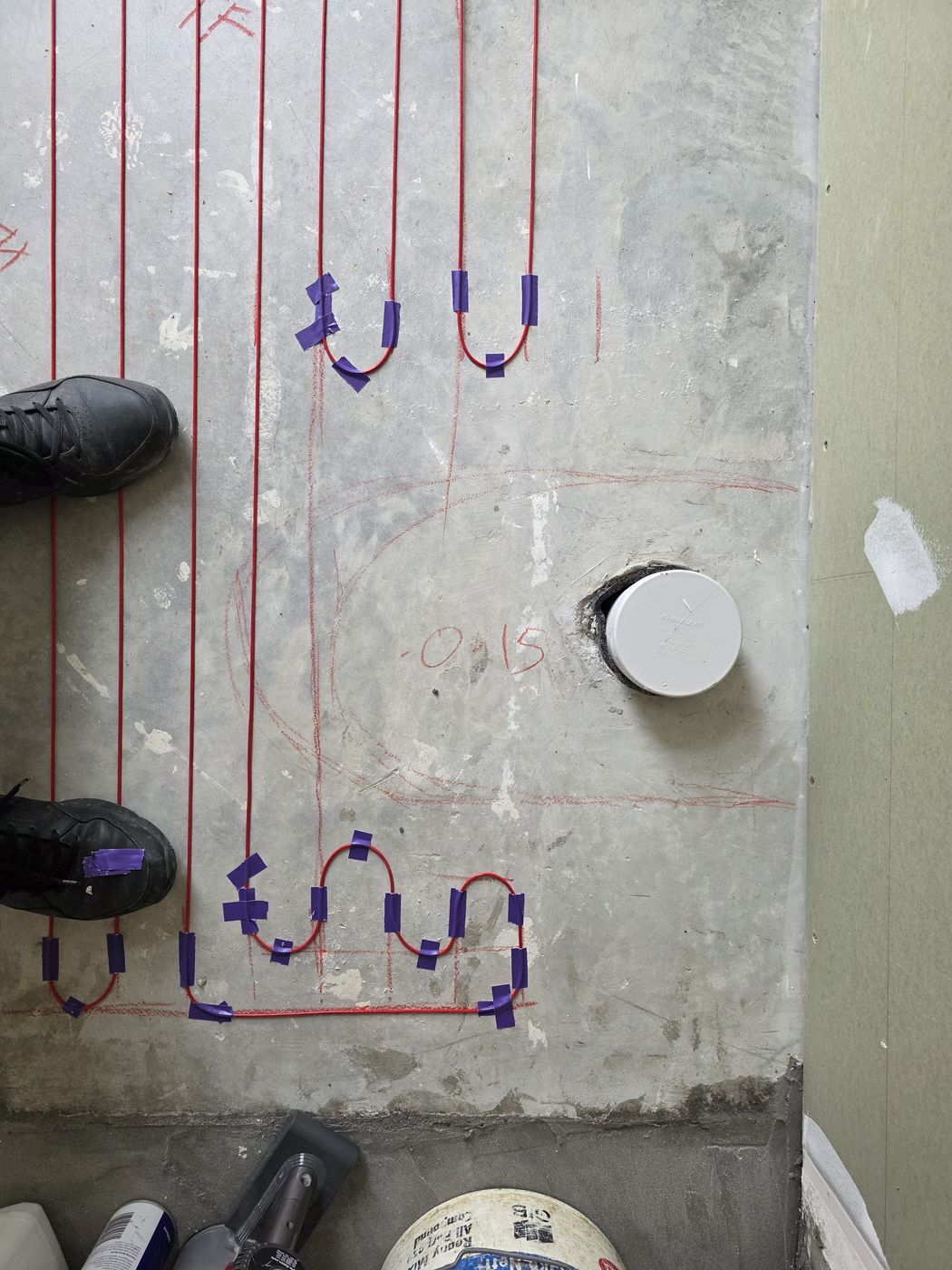 Electric underfloor heating by Floorheat NZ — the heating cable laid out across a bathroom floor before the screed goes on, the same system we fit across East Auckland
