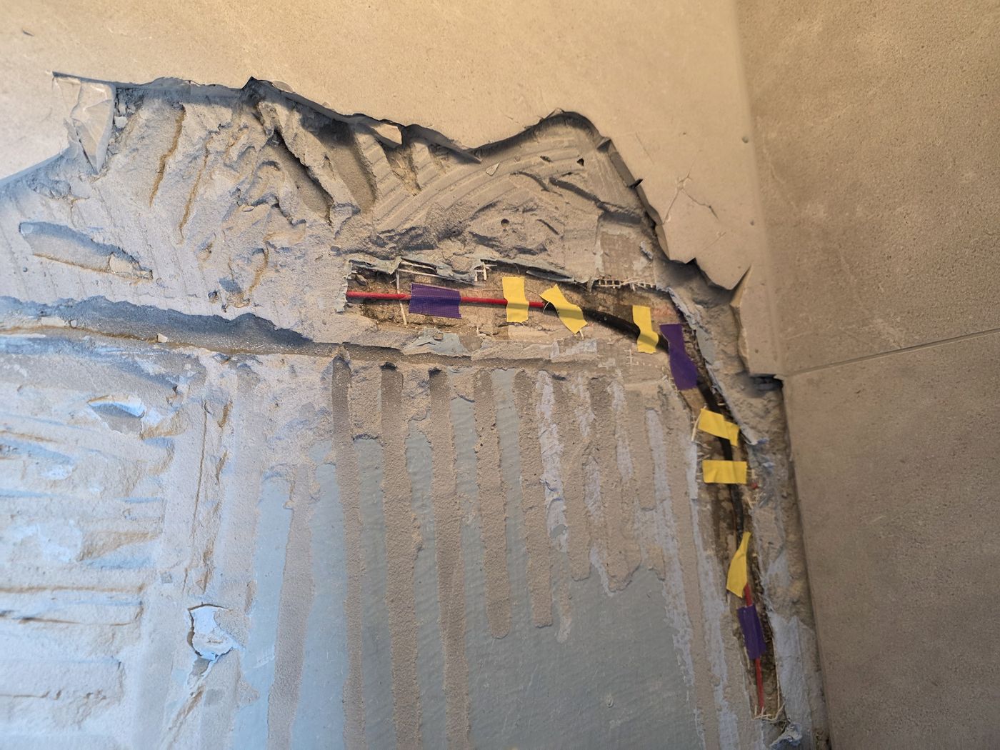 Electric underfloor heating by Floorheat NZ — the levelling screed going over the heating cable, ready for tiling, the same system we fit across South Auckland